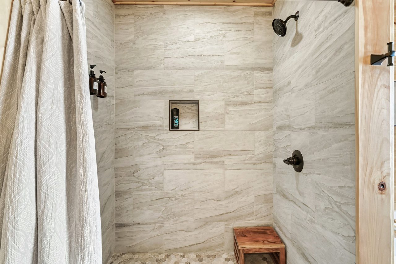 Bath 1: Entry level en-suite with tub and standing shower